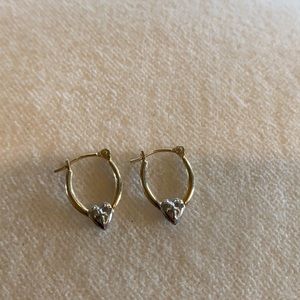 Small gold hoop earrings with silver heart and cross